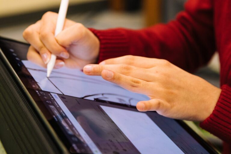 person-using-pencil-to-design-on-tablet-scaled-1400x933-1
